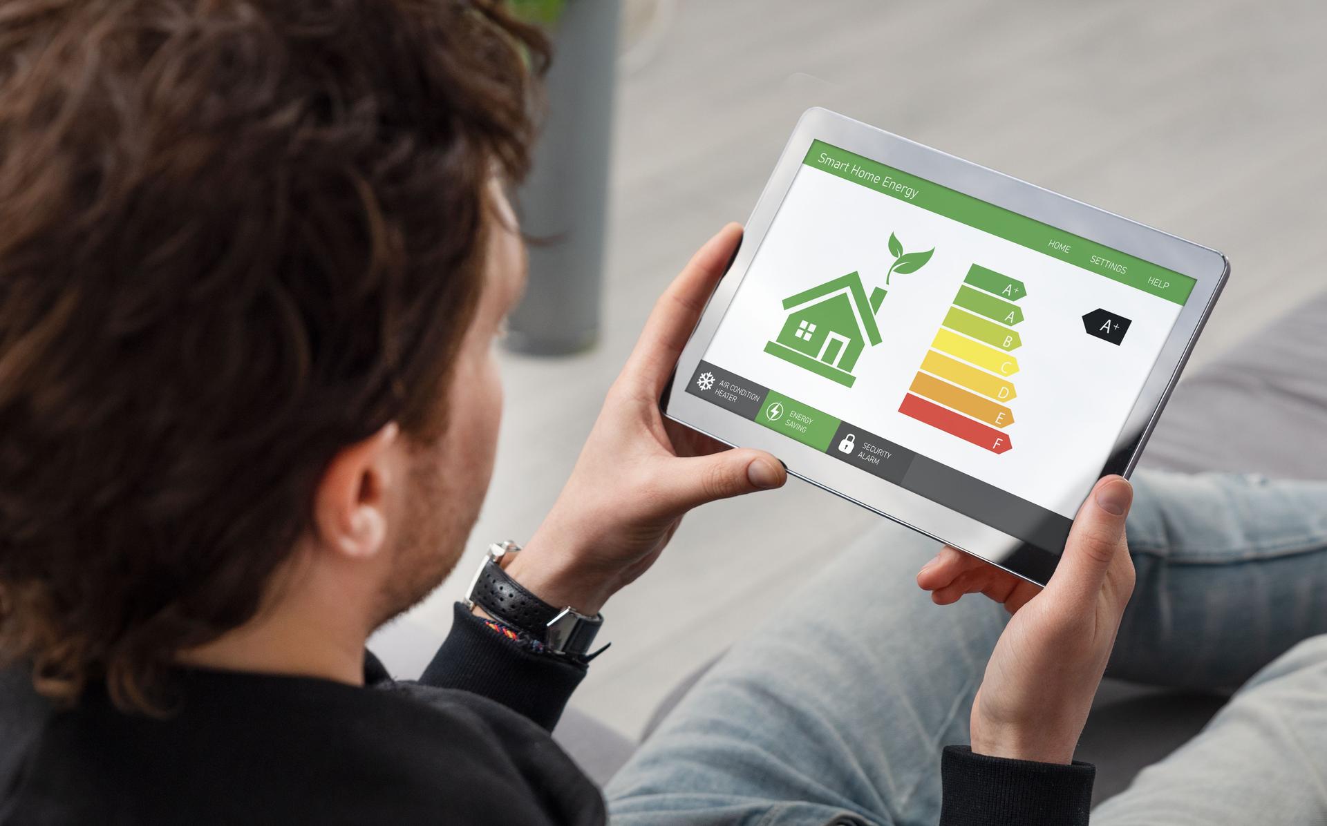Energy efficiency mobile app on screen, eco house