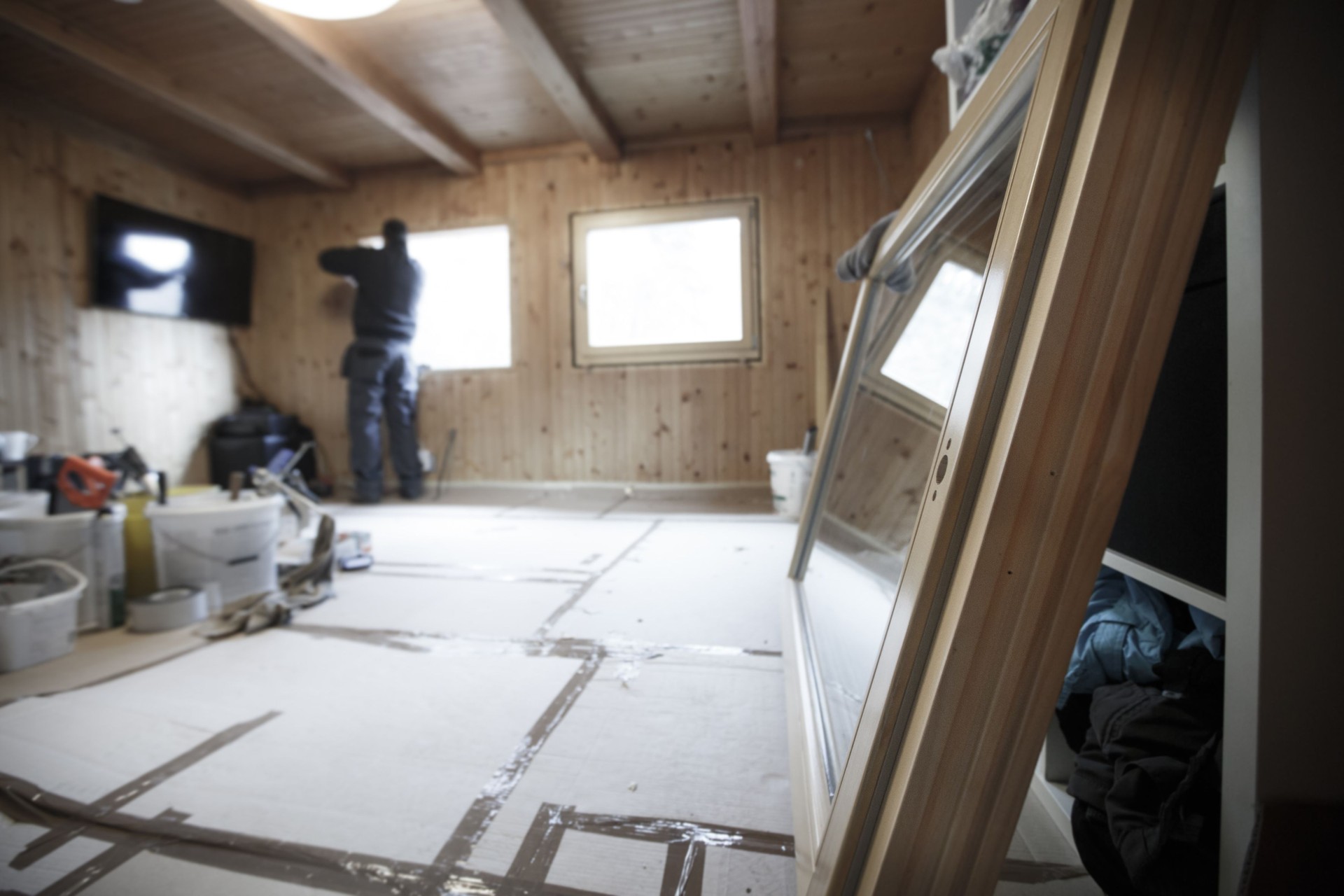 Worker installing new wooden windows